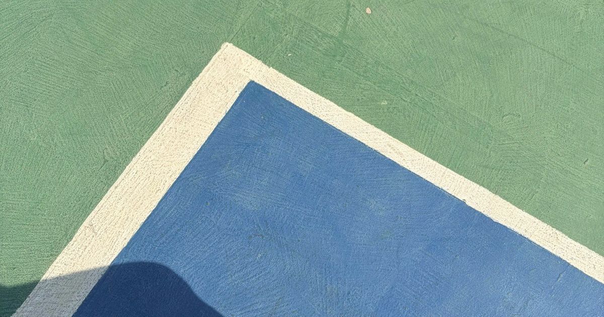 Court shoes on a blue and green outdoor hard court